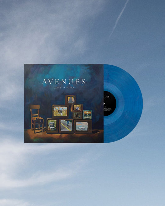 A cerulean blue vinyl partially pulled out from the jacket label for John Fellner's album, Avenues, set in front of a blue sky background.